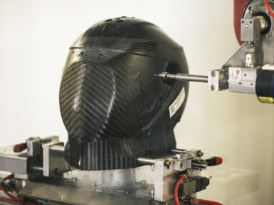 Trimming operations with Belotti TRIM 5-axis machining center on a Schuberth helmet with carbon fiber shell